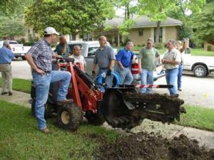 the sprinkler installation team dredges a new line trench